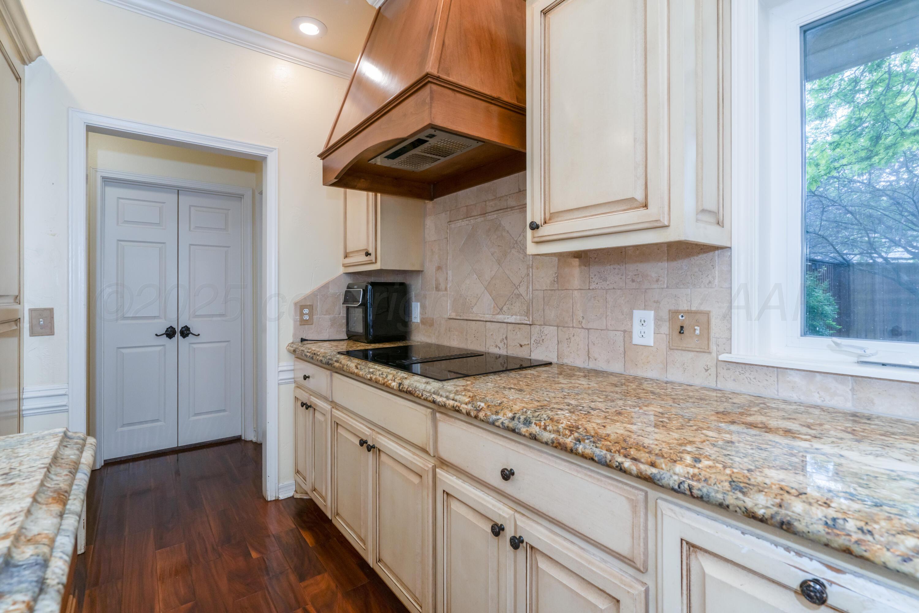 3501 Van Winkle Drive Amarillo, TX 79121 - Photo 9 of 35 a kitchen with granite countertop cabinets stainless steel appliances a sink and wooden floor