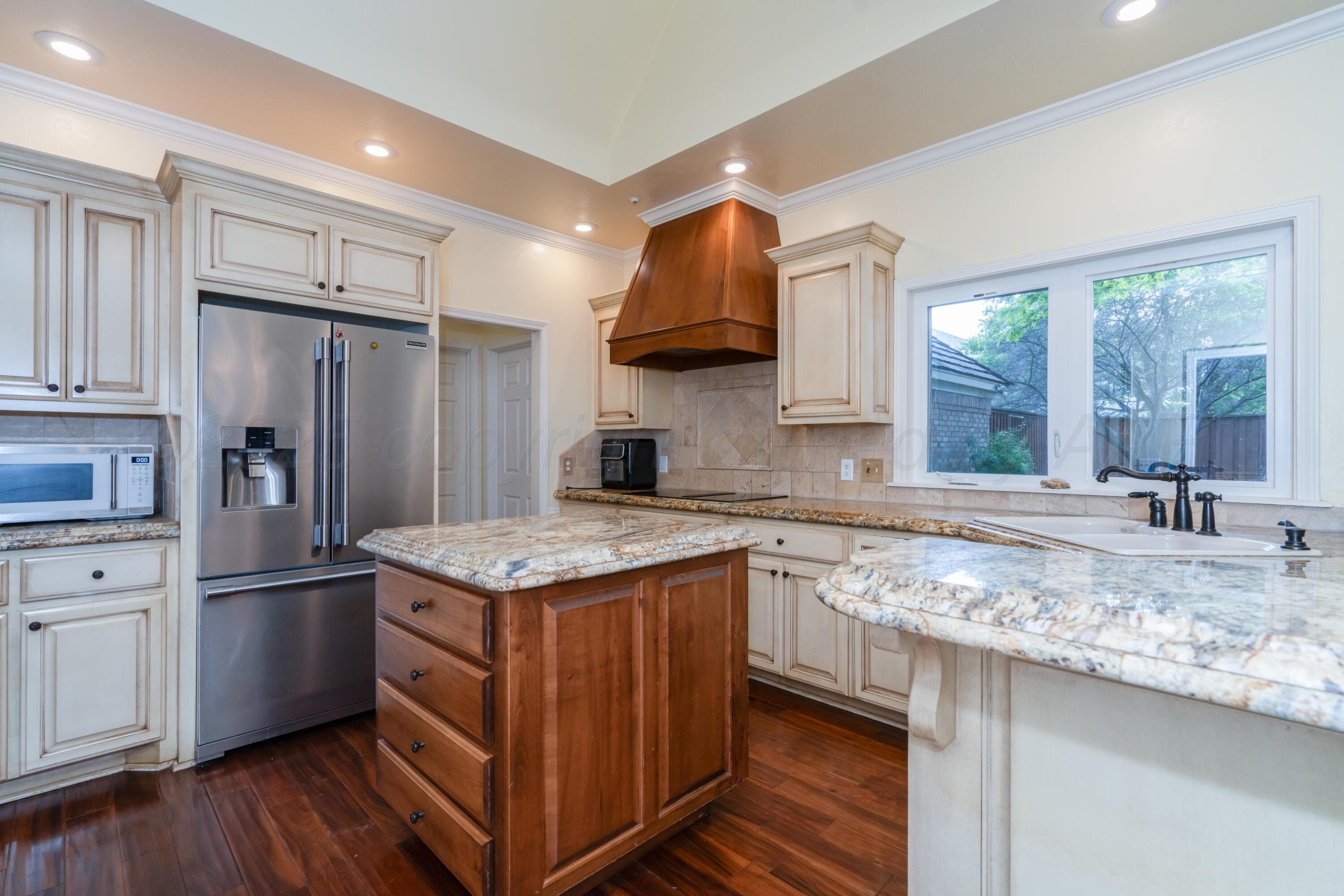 3501 Van Winkle Drive Amarillo, TX 79121 - Photo 10 of 35 a kitchen with stainless steel appliances granite countertop a sink stove and refrigerator