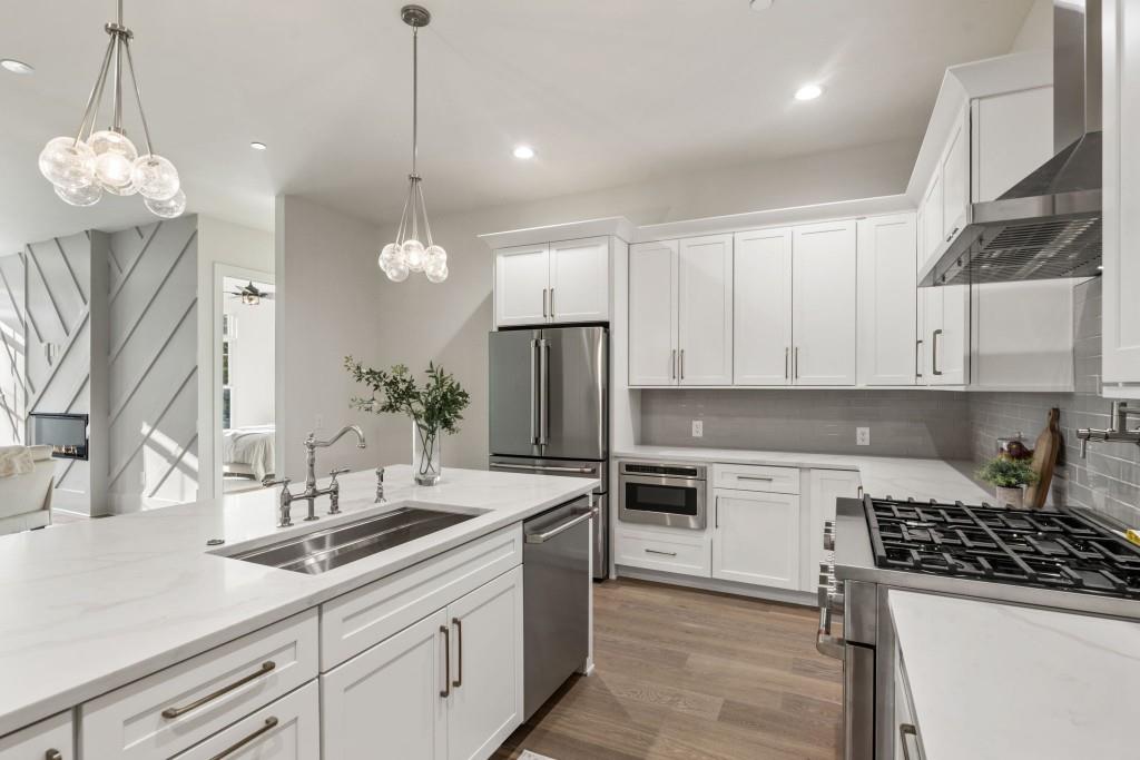 12455 Broadwell Road, Unit 202 Milton, GA 30004 - Photo 12 of 31 a kitchen with a sink a stove a refrigerator and cabinets