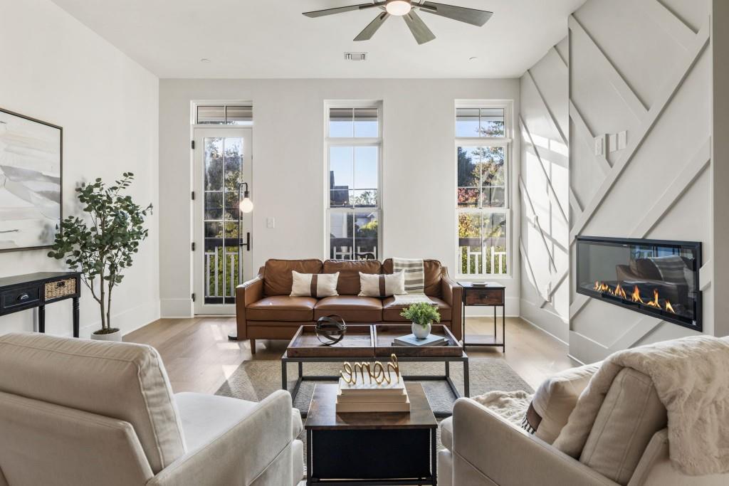 12455 Broadwell Road, Unit 202 Milton, GA 30004 - Photo 17 of 31 a living room with furniture a fireplace and a chandelier