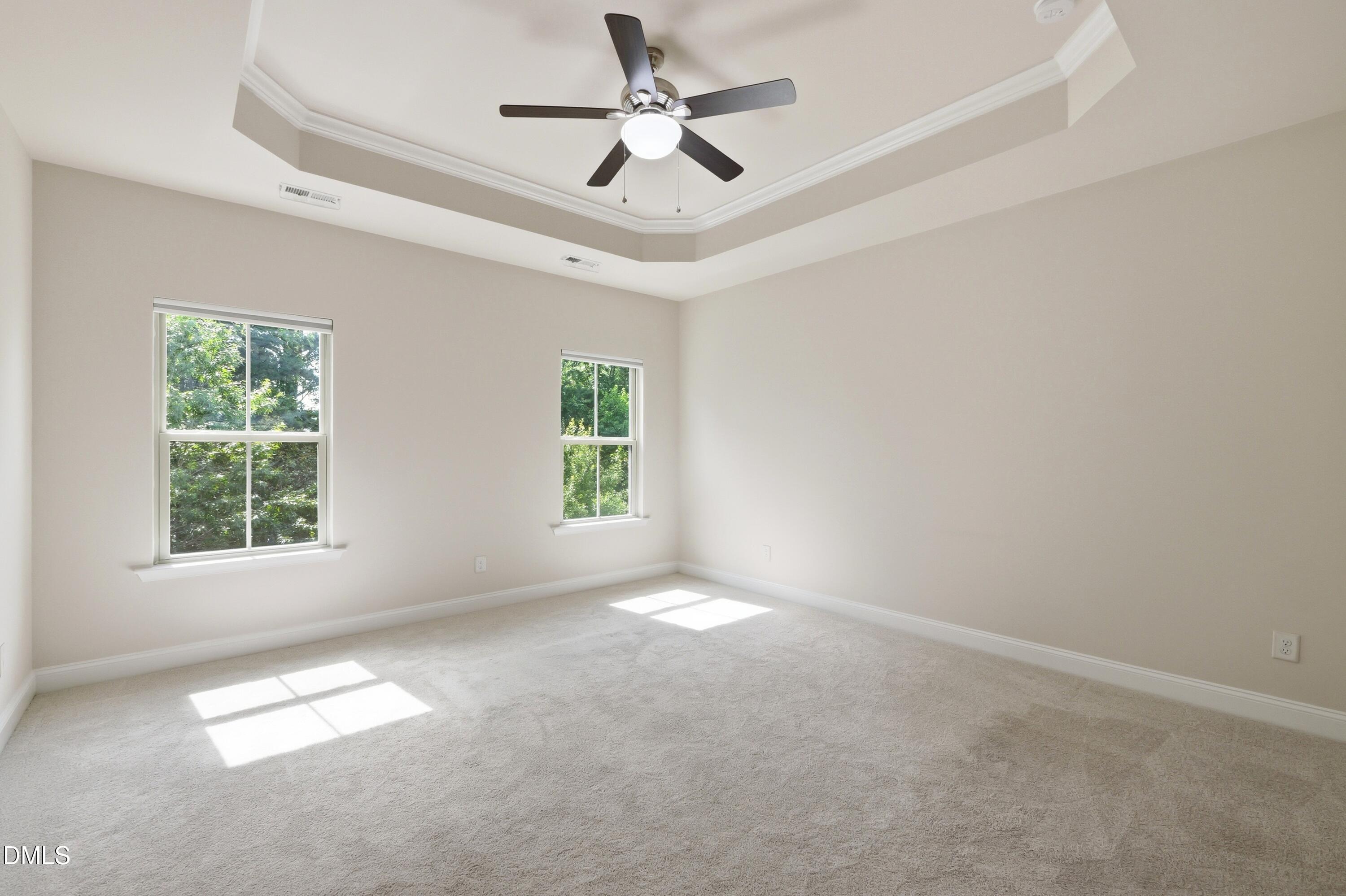 1004 Waymaker Court Apex, NC 27502 - Photo 14 of 30 an empty room with windows and ceiling fan