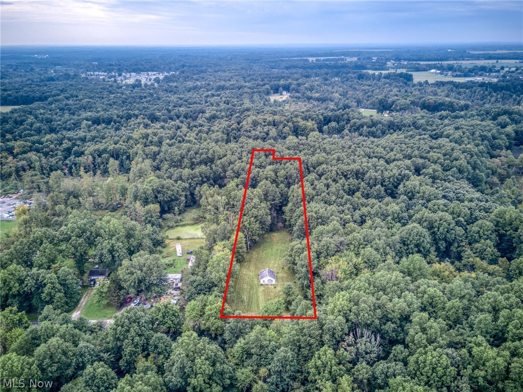 8386 Yale Road Rootstown, OH 44272 - Photo 31 of 46 Spacious wooded parcel featuring a single-story residence with a light-colored roof