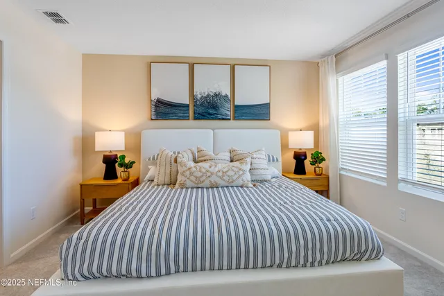 a bedroom with a bed and window