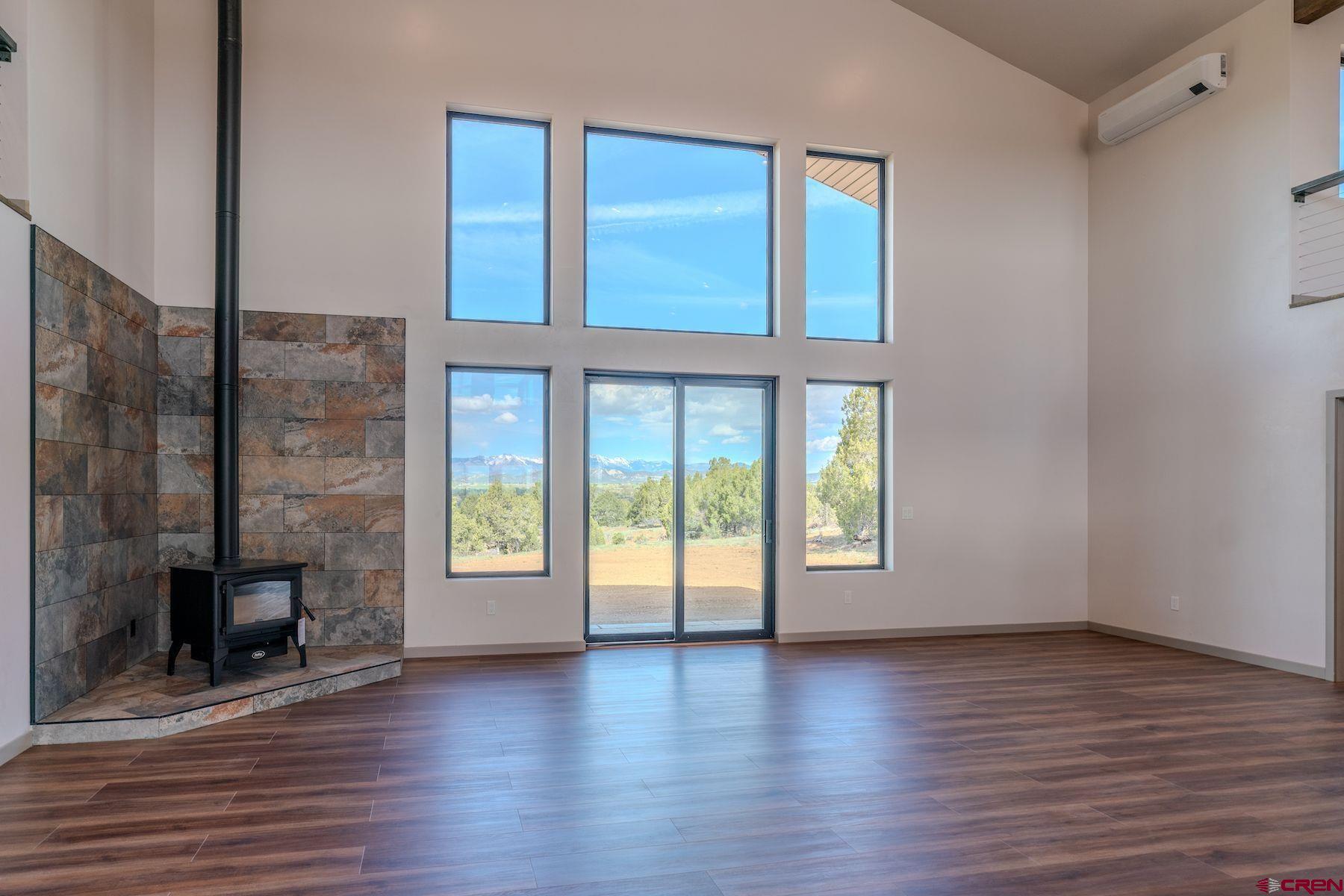 2077 Wrangler Way Durango, CO 81303 - Photo 13 of 43 a view of an empty room with window and wooden floor