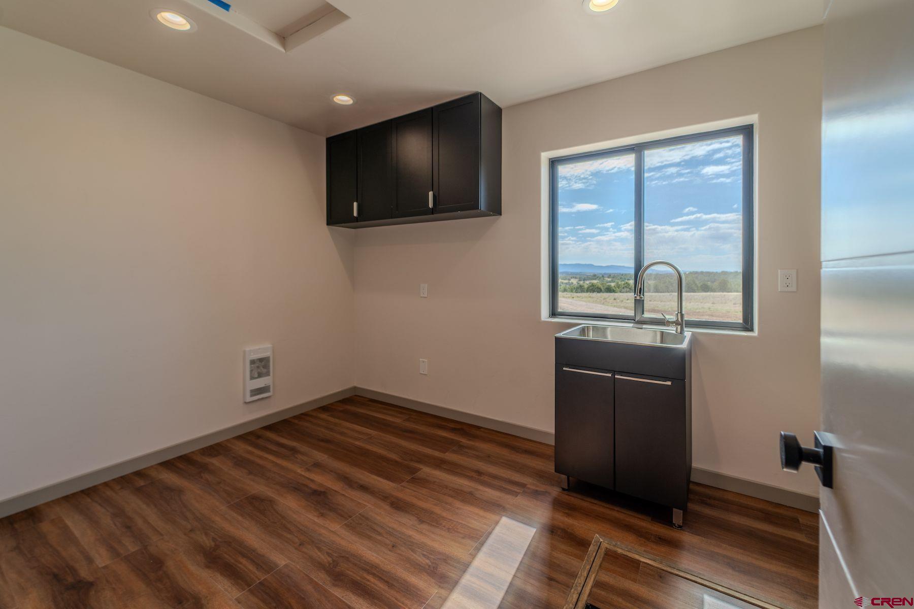 2077 Wrangler Way Durango, CO 81303 - Photo 19 of 43 a view of a livingroom with wooden floor and windows