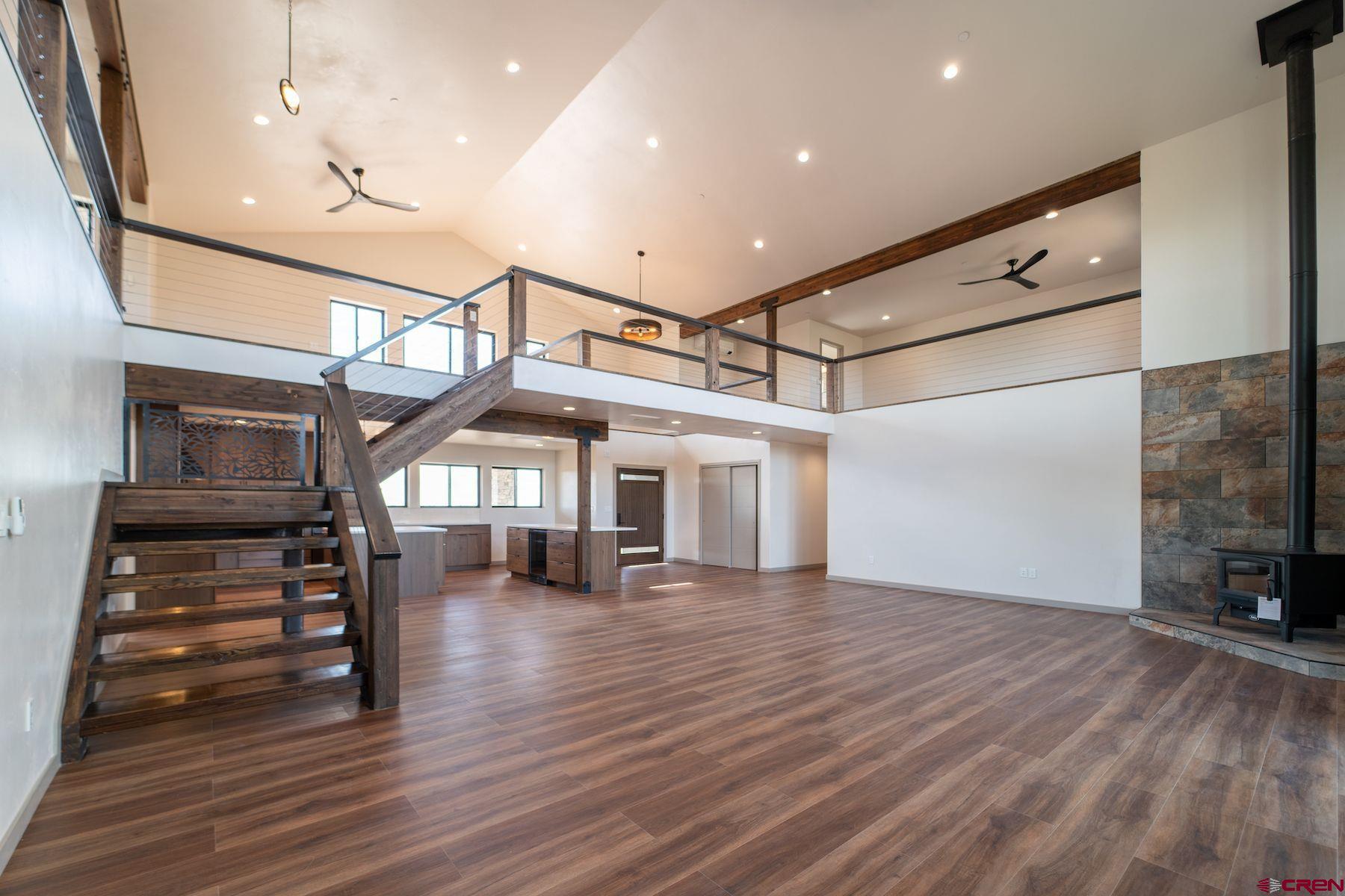2077 Wrangler Way Durango, CO 81303 - Photo 3 of 43 a view of a livingroom with wooden floor and stairs