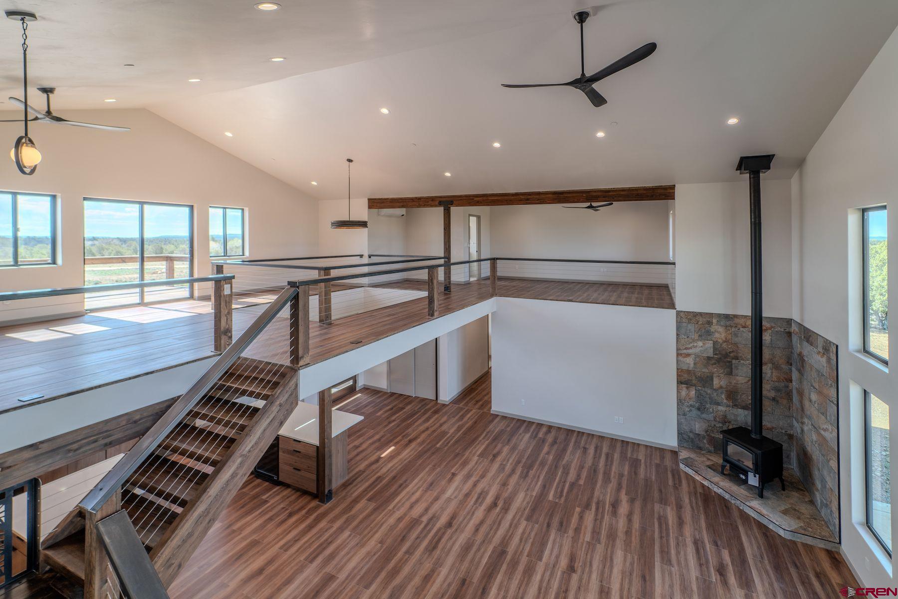 2077 Wrangler Way Durango, CO 81303 - Photo 31 of 43 a room with lots of wooden furniture and a ceiling fan