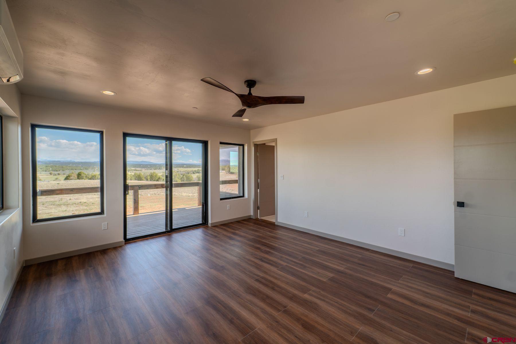 2077 Wrangler Way Durango, CO 81303 - Photo 33 of 43 a view of an empty room with a window and wooden floor