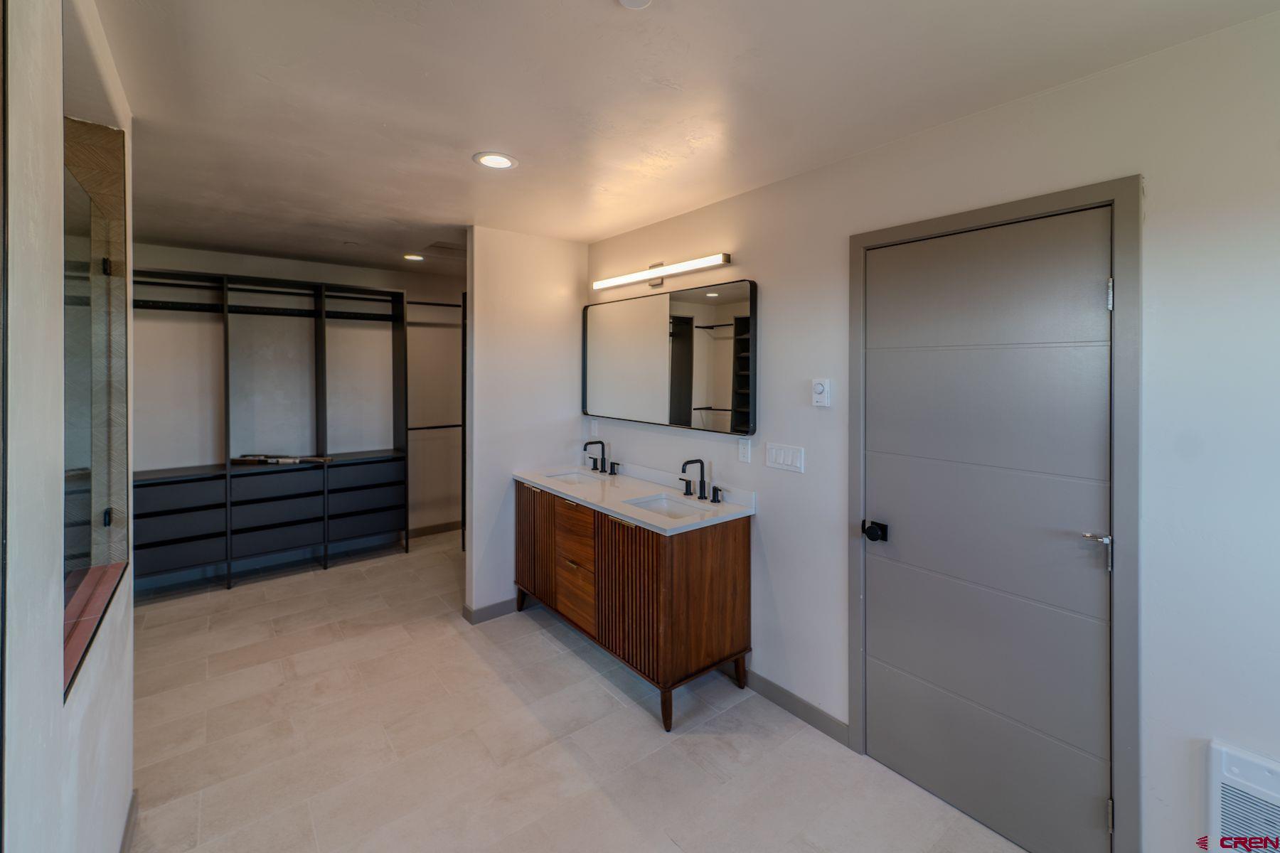 2077 Wrangler Way Durango, CO 81303 - Photo 35 of 43 a bathroom with a tub sink and mirror