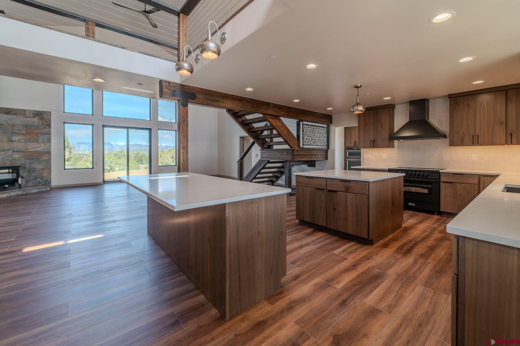 2077 Wrangler Way Durango, CO 81303 - Photo 6 of 43 a kitchen with stainless steel appliances granite countertop a sink a stove and a wooden floors