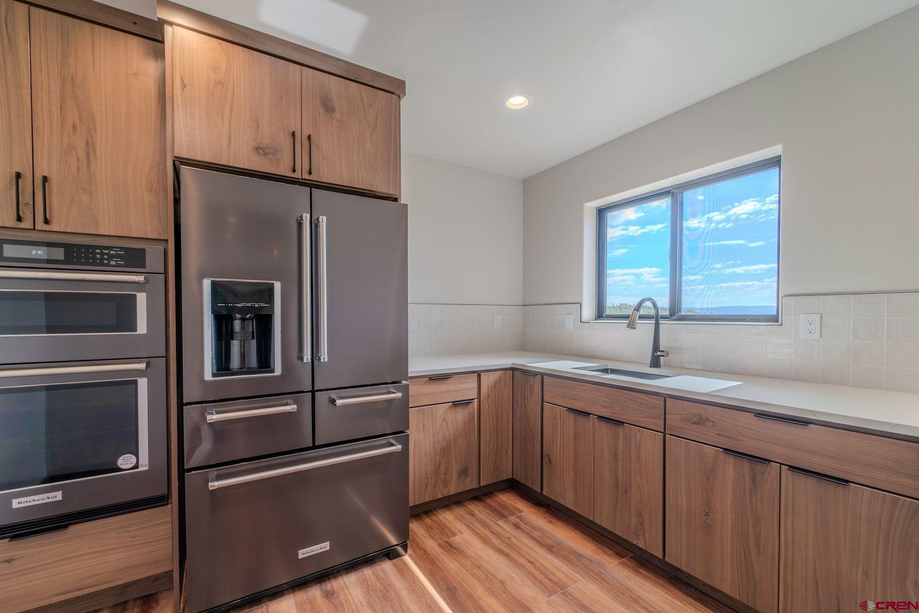 2077 Wrangler Way Durango, CO 81303 - Photo 8 of 43 a kitchen with a refrigerator and a sink