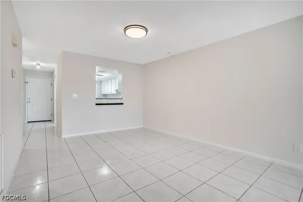 an empty room with windows and painted walls