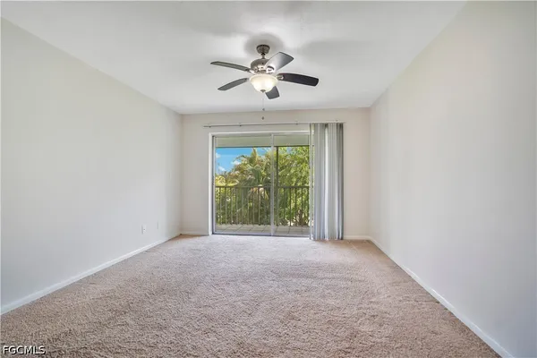 a view of a livingroom with a ceiling fan and window