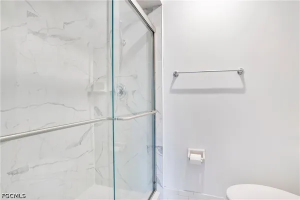 a bathroom with a shower and toilet