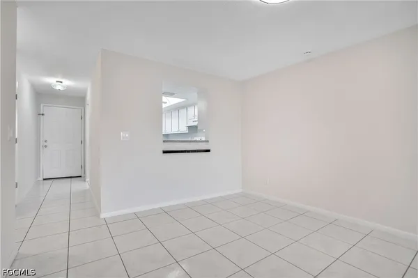 an empty room with white walls and tiles