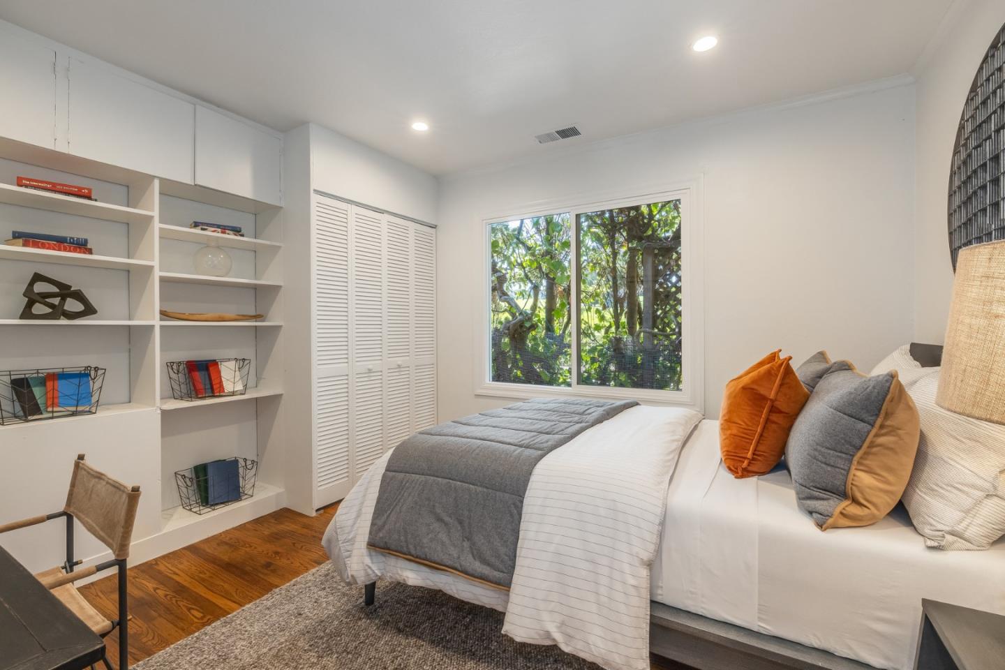 419 Millwood Drive Millbrae, CA 94030 - Photo 19 of 32 a bedroom with a bed a window and book shelf
