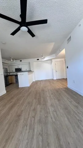 a kitchen with a wooden floor and cabinets