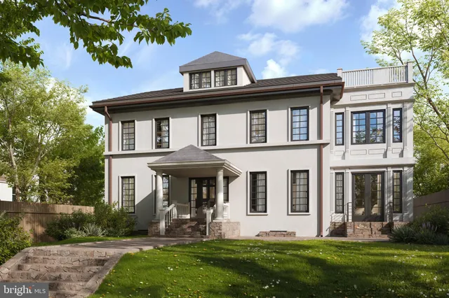 a front view of a house with a yard and trees