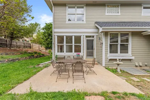 a building outdoor space with patio furniture and garden