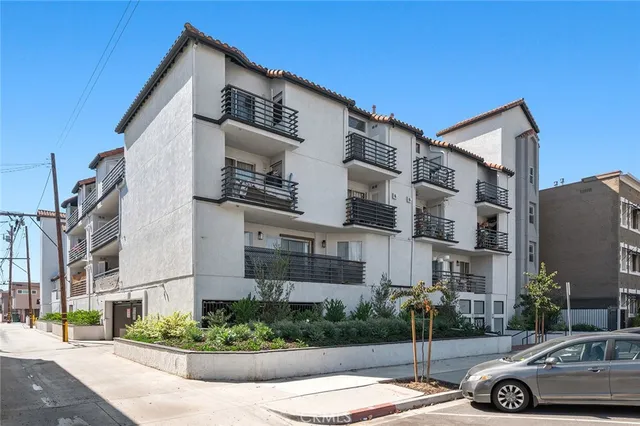 a car parked in front of a white building