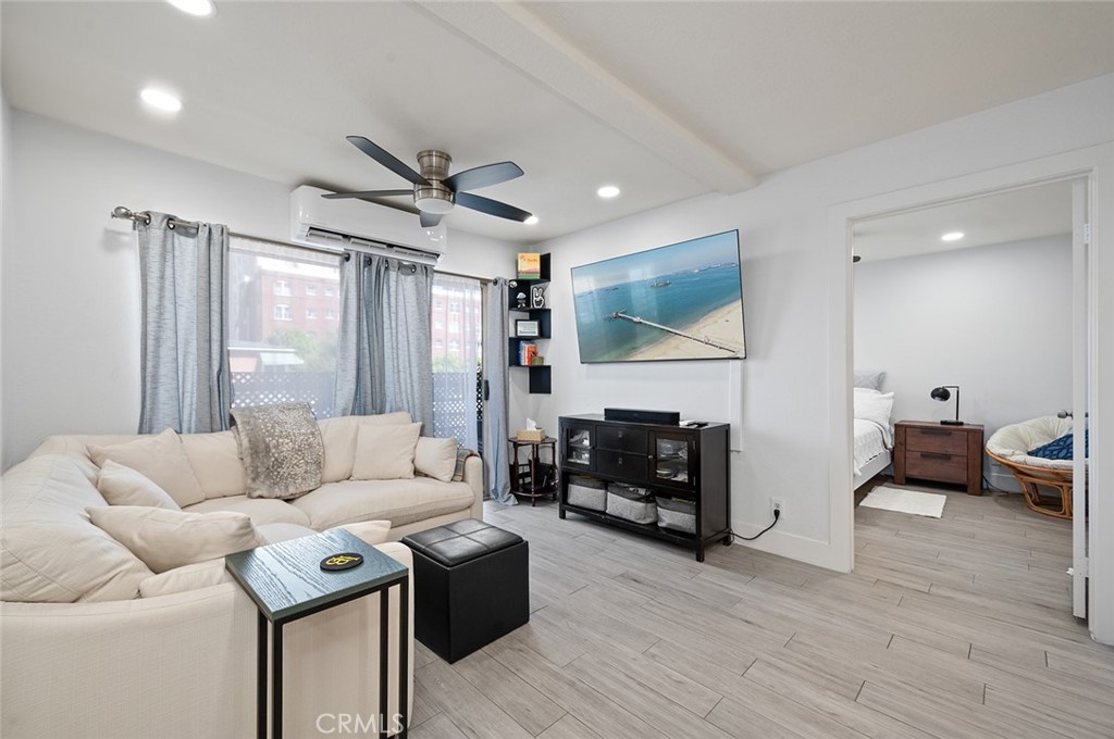 327 Chestnut Avenue, Unit 102 Long Beach, CA 90802 - Photo 2 of 26 a living room with furniture fireplace and a flat screen tv