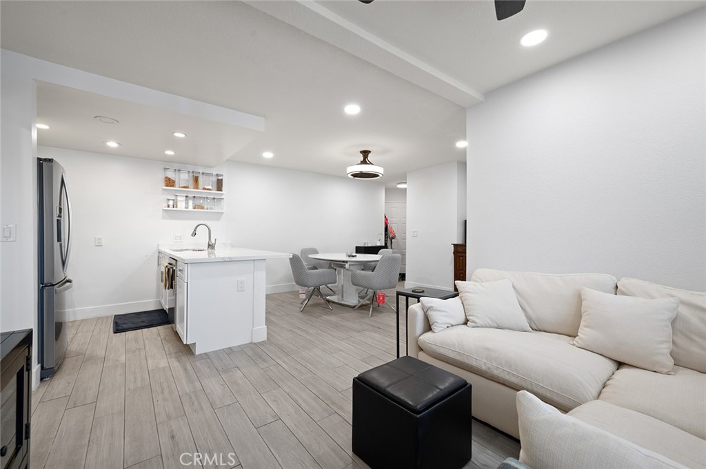 327 Chestnut Avenue, Unit 102 Long Beach, CA 90802 - Photo 3 of 26 a living room with furniture and a wooden floor