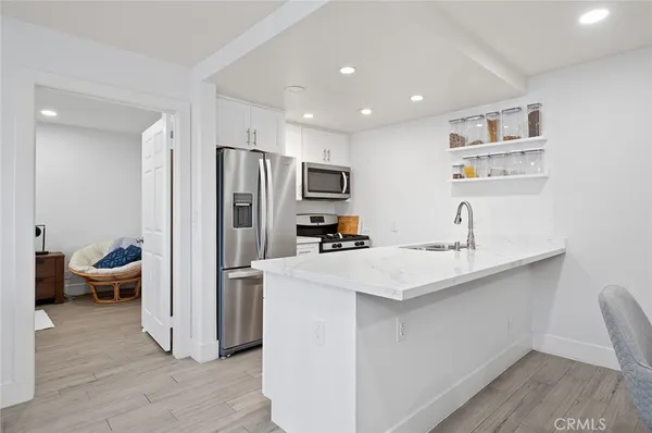 a kitchen with refrigerator and sink