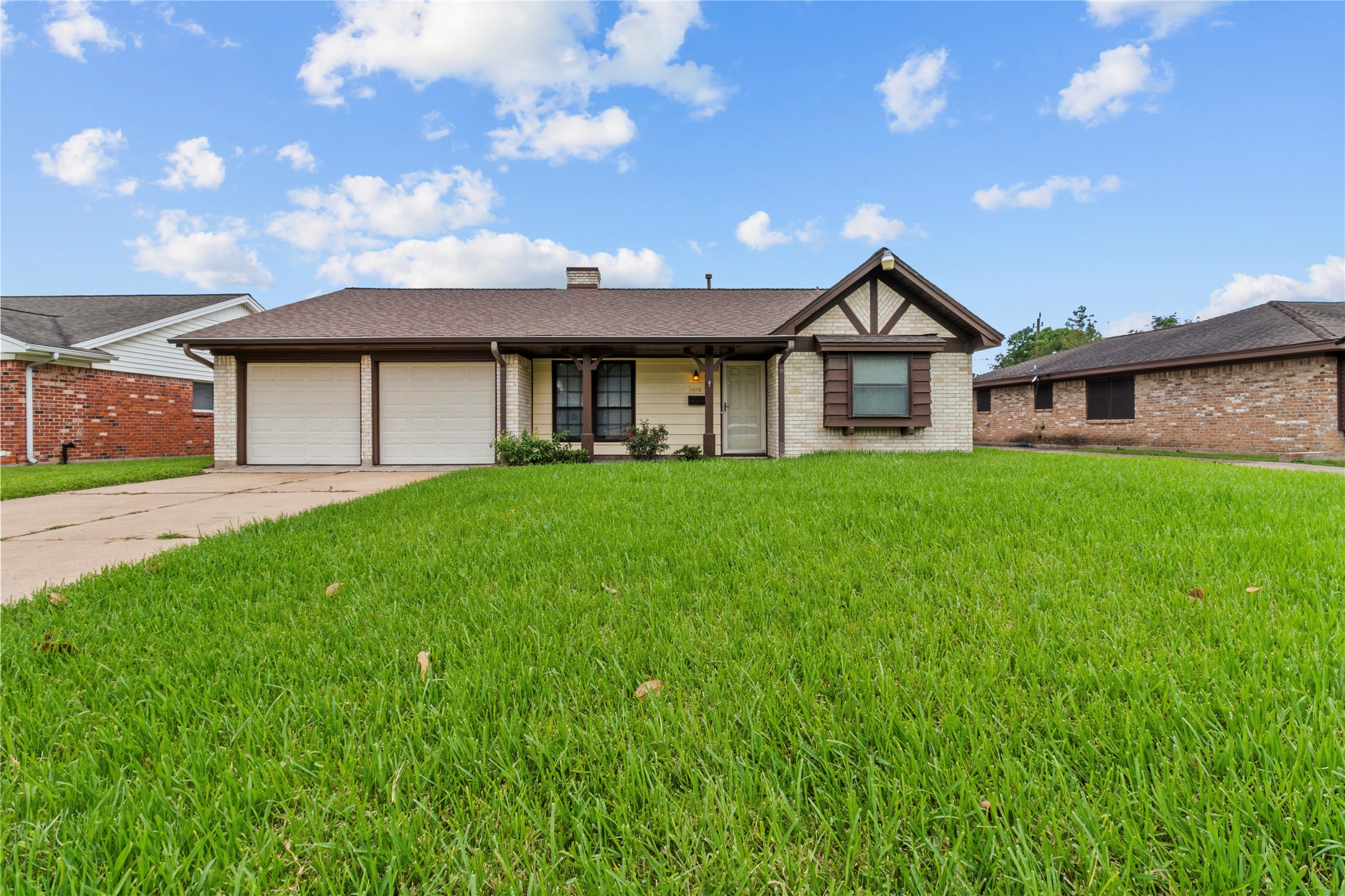 a view of a house with a big yard and large tree