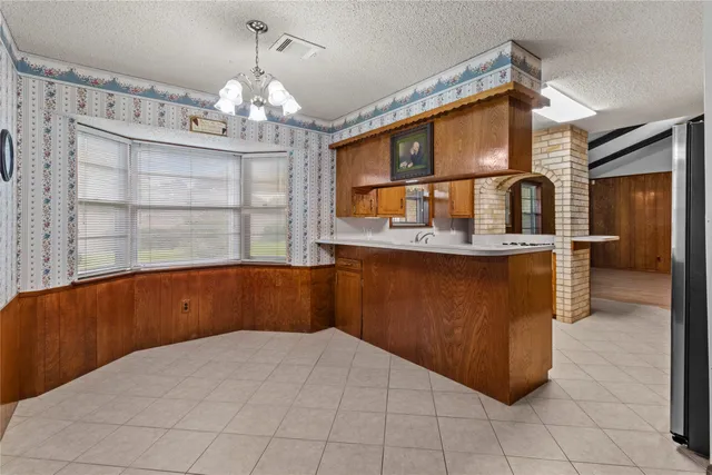 a kitchen with stainless steel appliances kitchen island granite countertop a cabinets