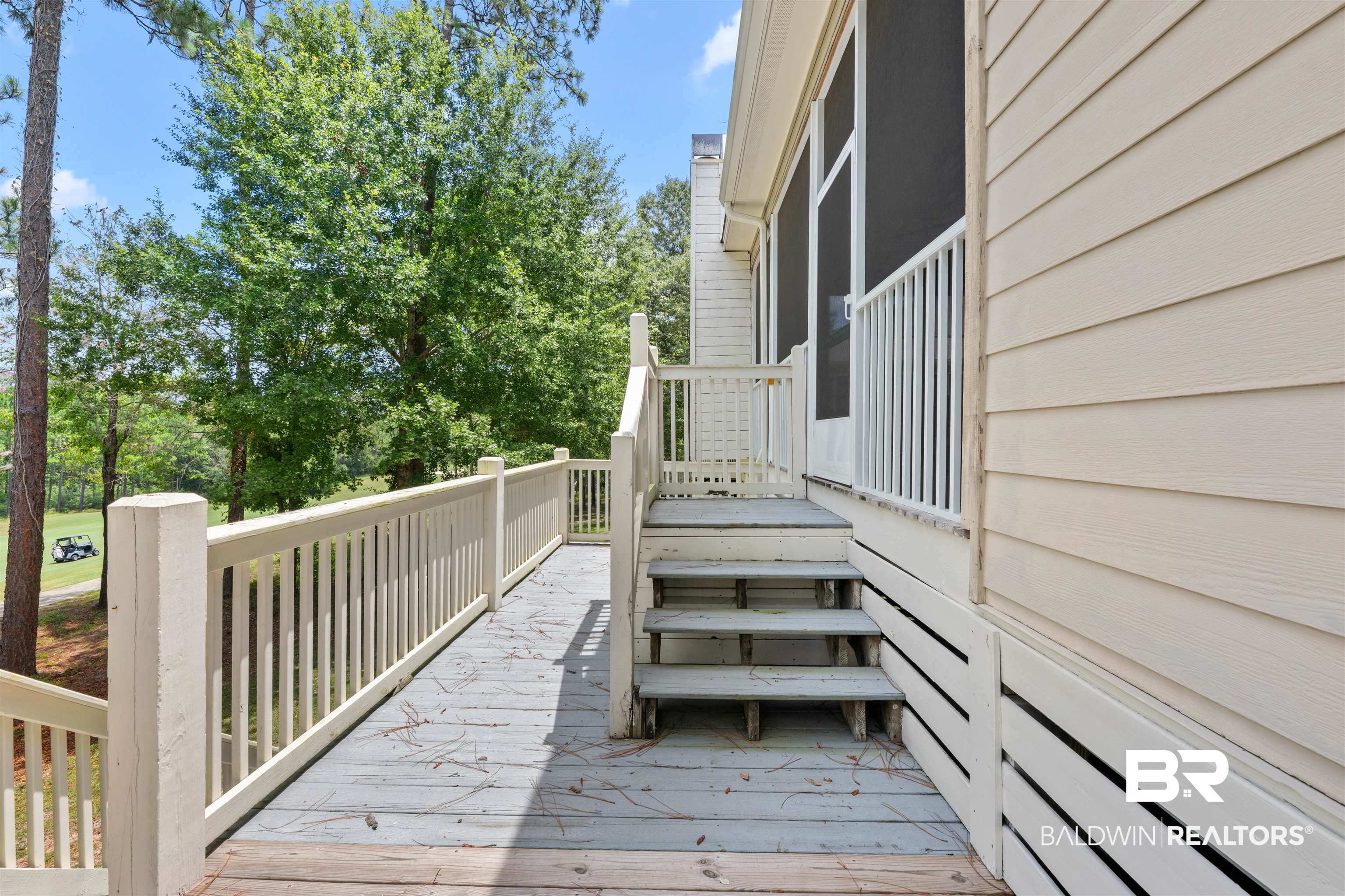 32700 Steelwood Ridge Road, Unit D Loxley, AL 36551 - Photo 31 of 41 Spacious exterior deck with wood flooring and painted railings