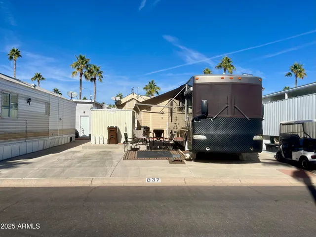 a view of a house with a yard table and chairs