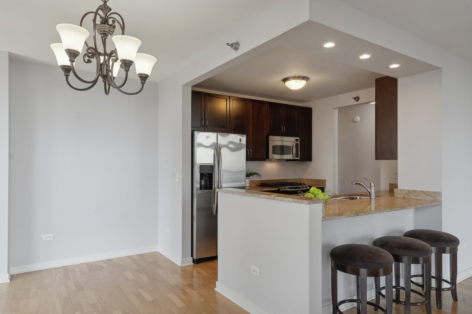 1160 South Michigan Avenue, Unit 2001 Chicago, IL 60605 - Photo 14 of 33 a kitchen with stainless steel appliances granite countertop a sink refrigerator and microwave