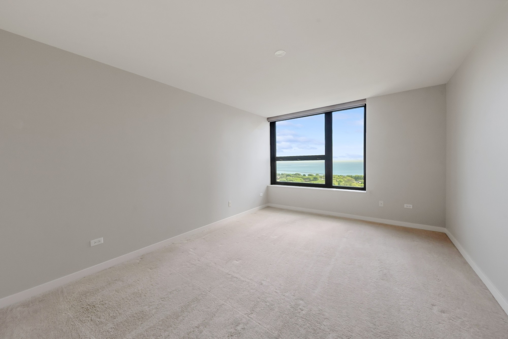 1160 South Michigan Avenue, Unit 2001 Chicago, IL 60605 - Photo 16 of 33 wooden floor in an empty room with a window