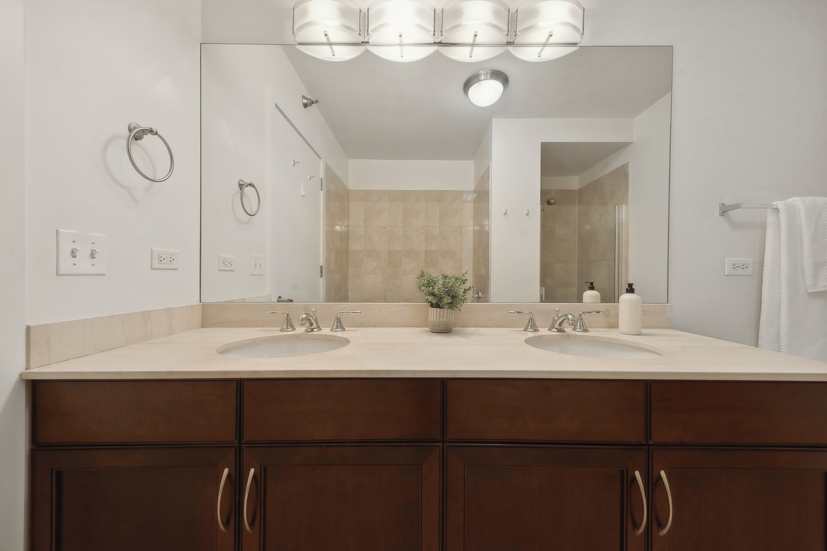 1160 South Michigan Avenue, Unit 2001 Chicago, IL 60605 - Photo 17 of 33 a bathroom with a double vanity sink and a mirror