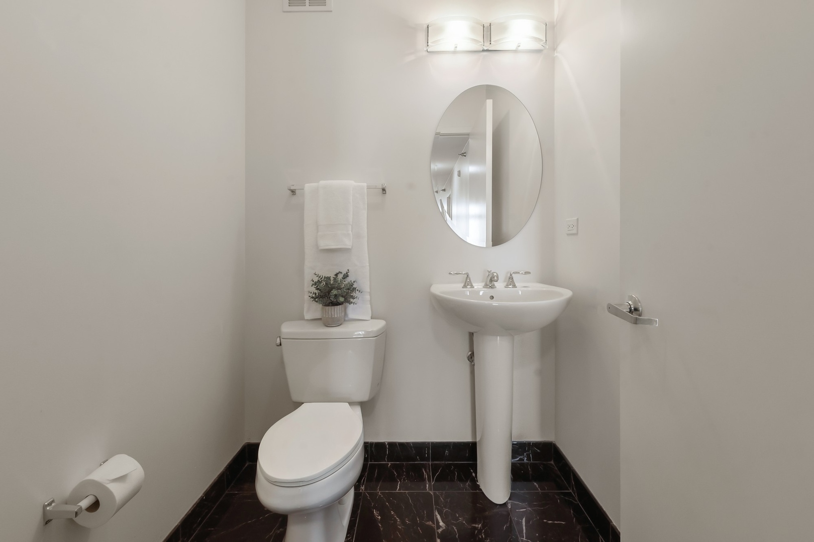 1160 South Michigan Avenue, Unit 2001 Chicago, IL 60605 - Photo 26 of 33 a bathroom with a toilet sink and mirror