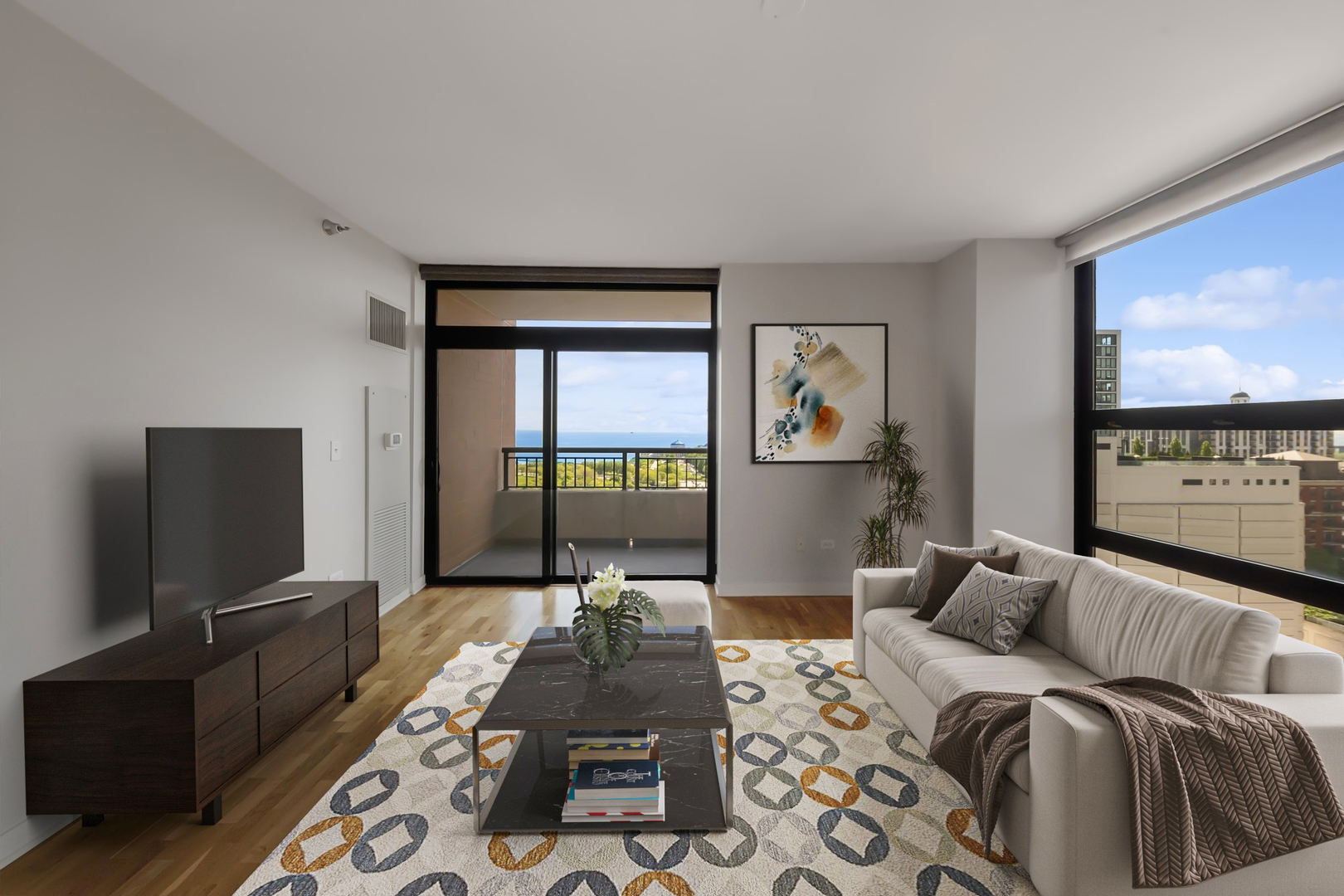 1160 South Michigan Avenue, Unit 2001 Chicago, IL 60605 - Photo 3 of 33 a living room with furniture a flat screen tv and a floor to ceiling window