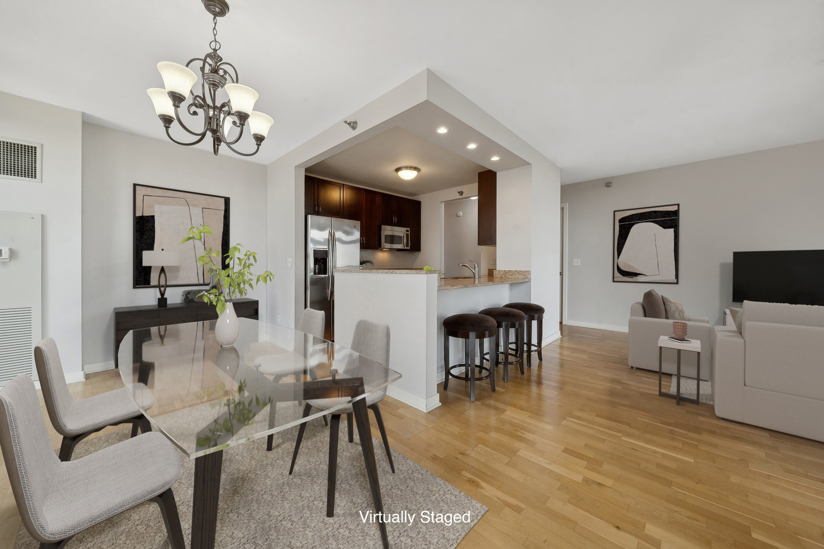 1160 South Michigan Avenue, Unit 2001 Chicago, IL 60605 - Photo 5 of 33 a view of a dining room with furniture a chandelier and wooden floor