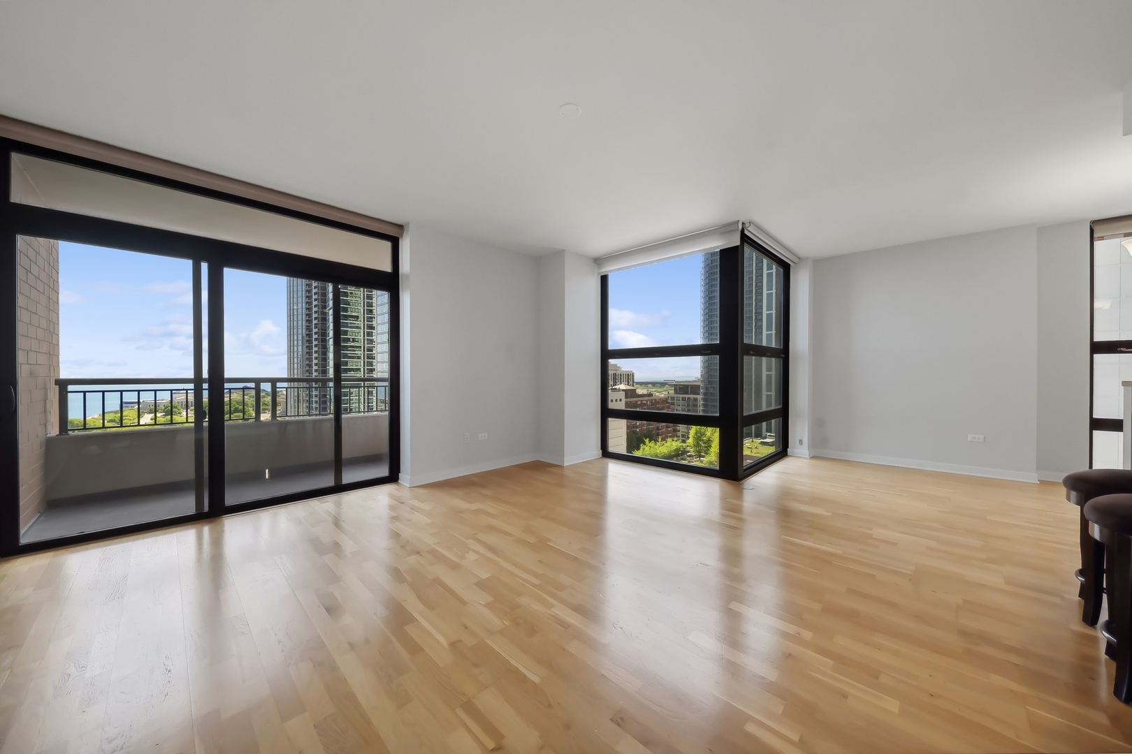 1160 South Michigan Avenue, Unit 2001 Chicago, IL 60605 - Photo 8 of 33 a view of an empty room with wooden floor and a window