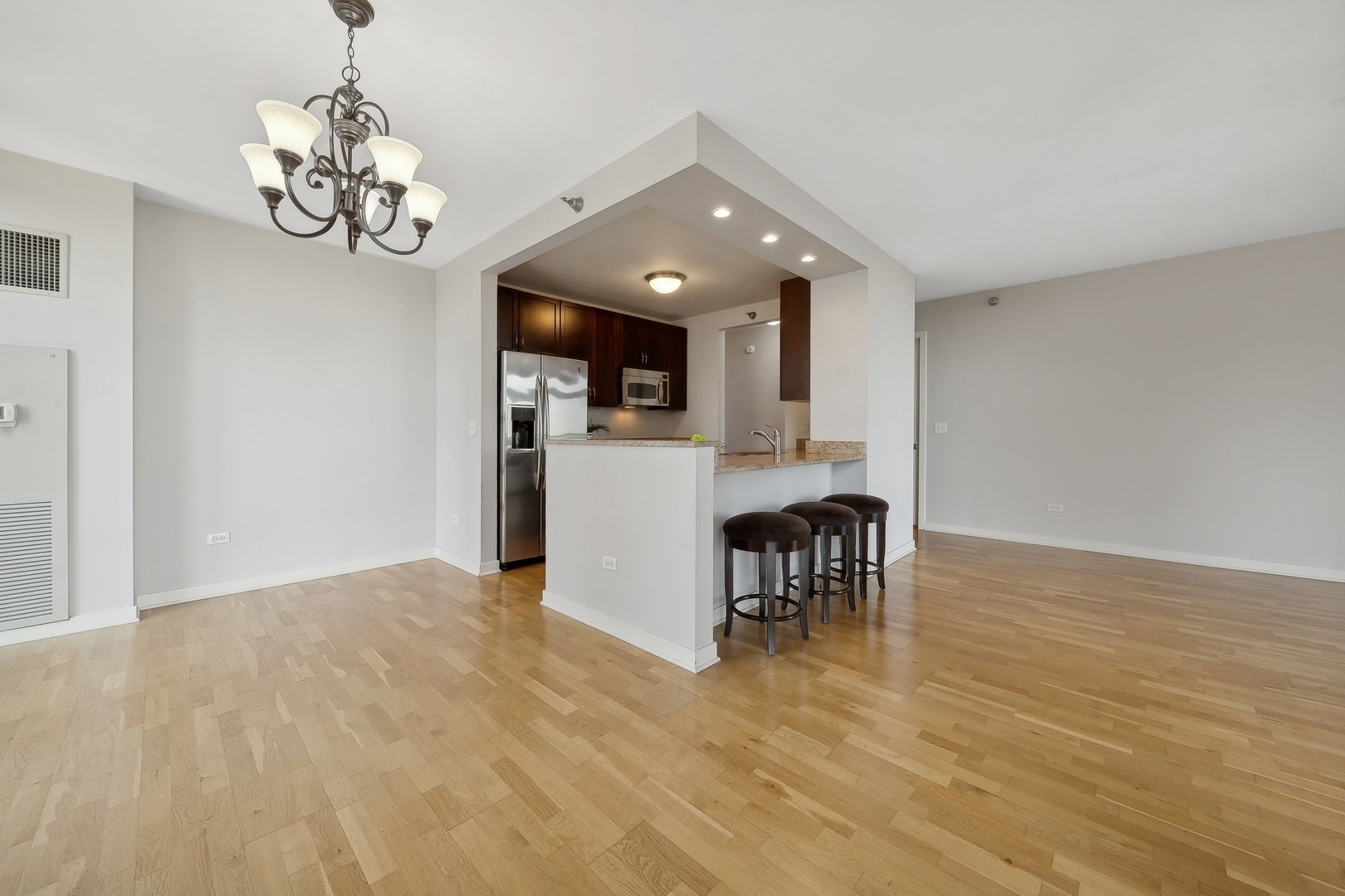 1160 South Michigan Avenue, Unit 2001 Chicago, IL 60605 - Photo 10 of 33 a view of a dining room with furniture a chandelier and wooden floor