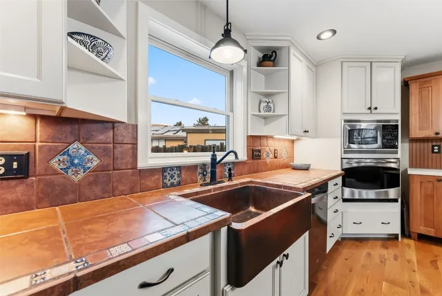 a kitchen with stainless steel appliances granite countertop a stove and a refrigerator