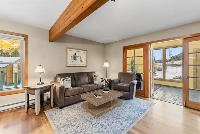a living room with furniture kitchen view and a dining table