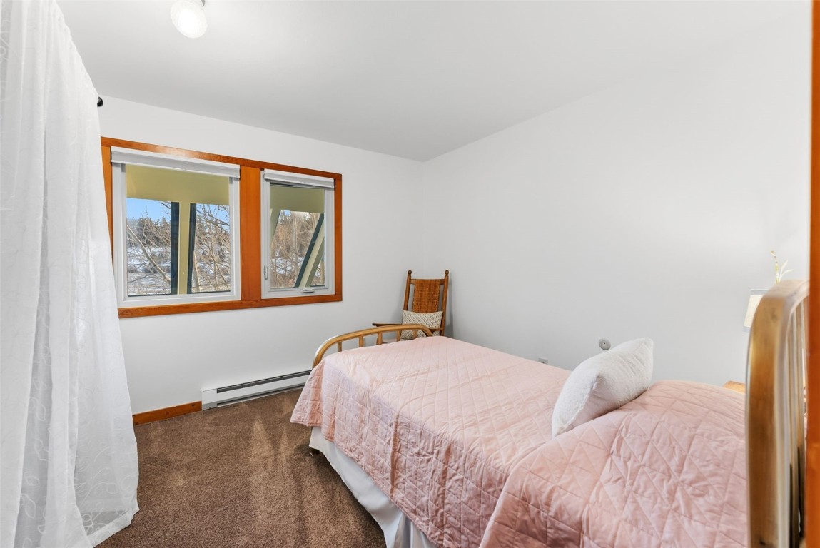 994 Summit Drive Dillon, CO 80435 - Photo 26 of 38 a bedroom with a bed and wooden floor