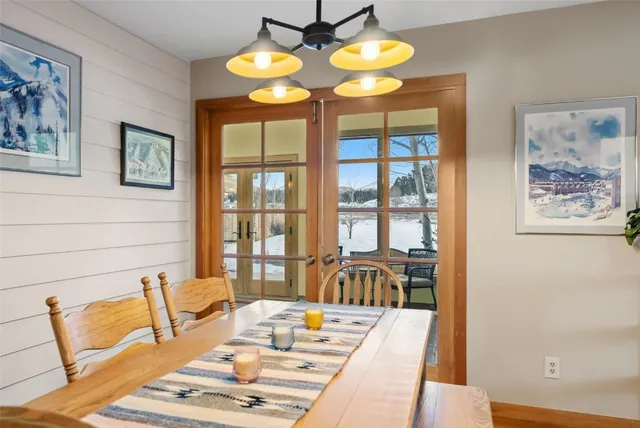 a kitchen with stainless steel appliances granite countertop a stove a refrigerator a oven a sink with a dining table and chairs