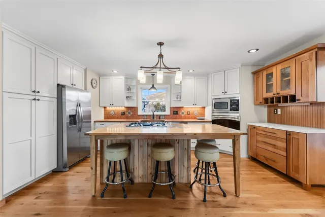 a kitchen that has a sink and a stove in it