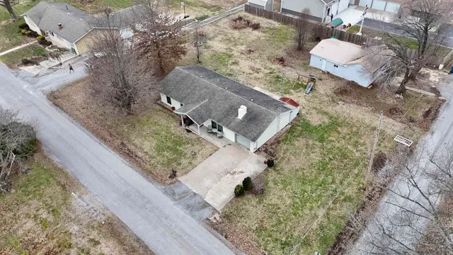 an aerial view of a house with a yard