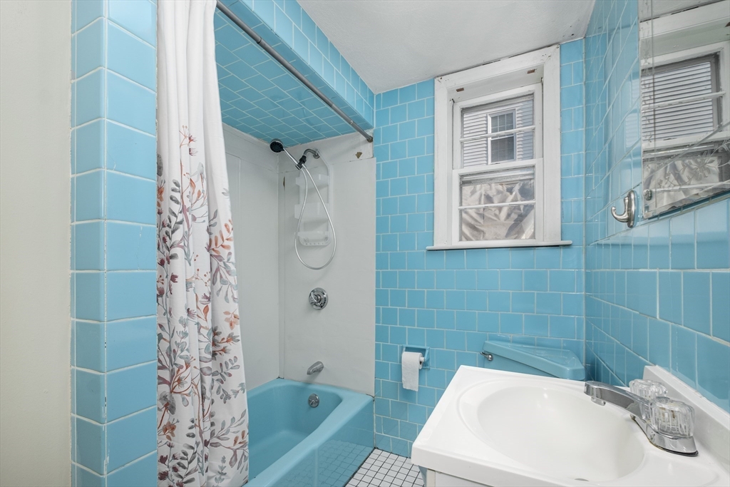 20 Hatch Street Everett, MA 02149 - Photo 11 of 16 a bathroom with a sink a toilet and shower