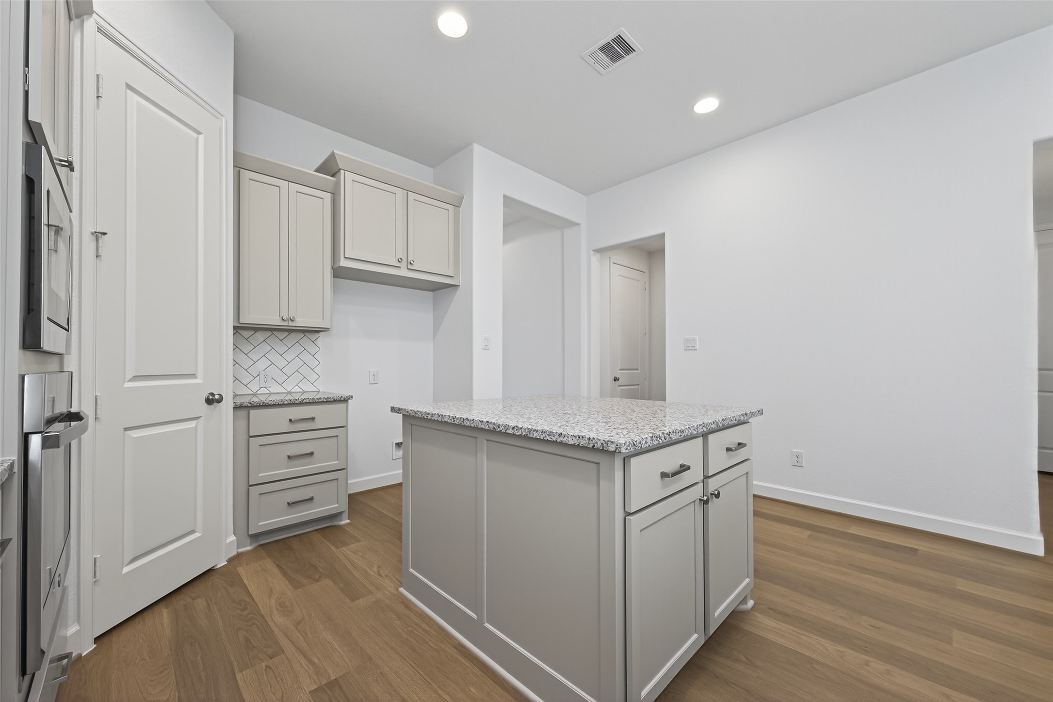 122 Sierra Strm Court Conroe, TX 77304 - Photo 11 of 40 a kitchen with stainless steel appliances cabinets and wooden floor