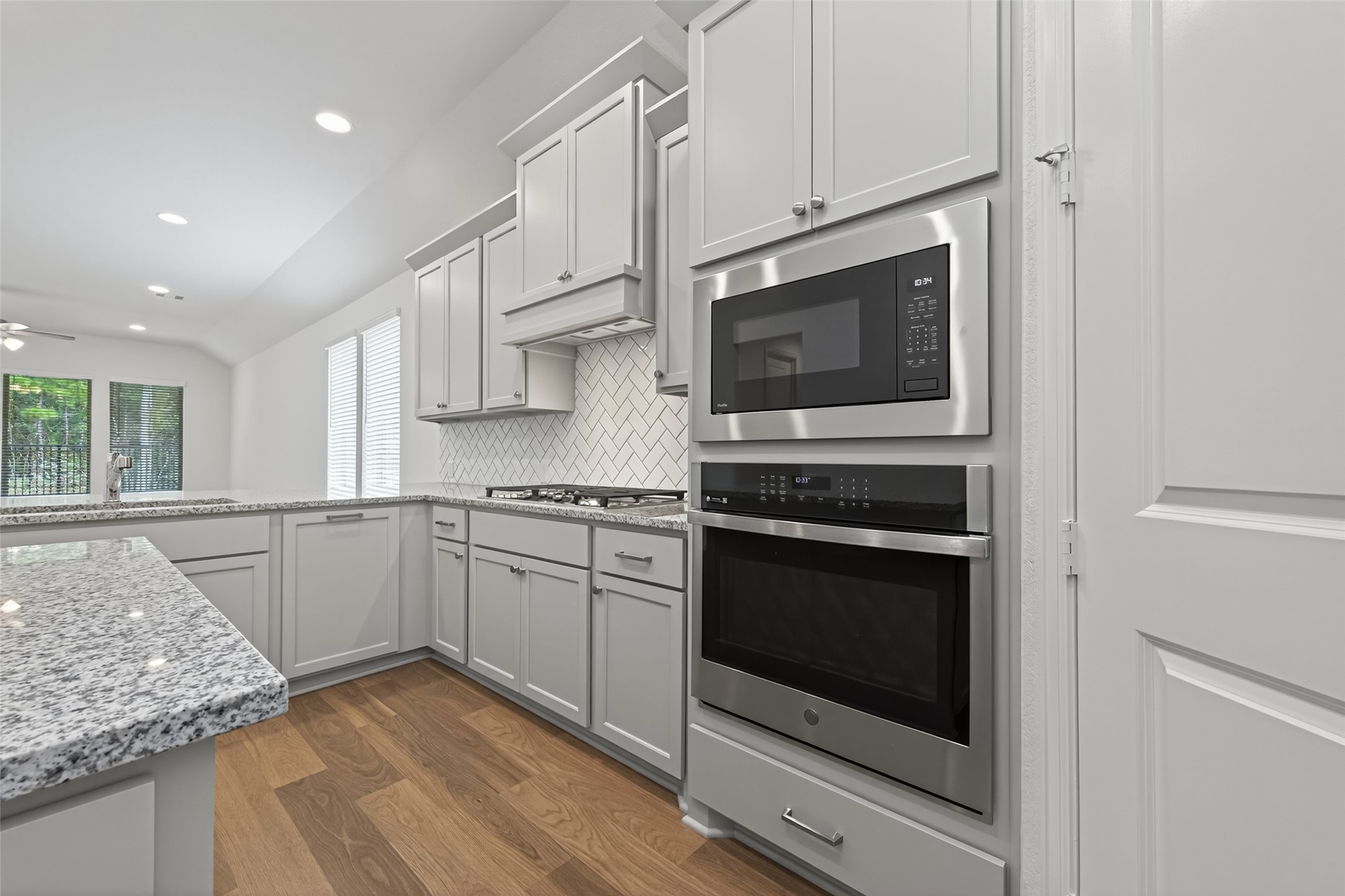 122 Sierra Strm Court Conroe, TX 77304 - Photo 13 of 40 a kitchen with stainless steel appliances granite countertop a stove microwave and sink