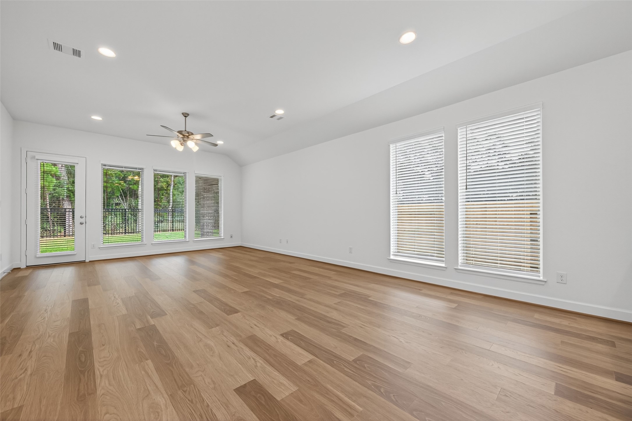 122 Sierra Strm Court Conroe, TX 77304 - Photo 15 of 40 a view of an empty room with wooden floor and a window