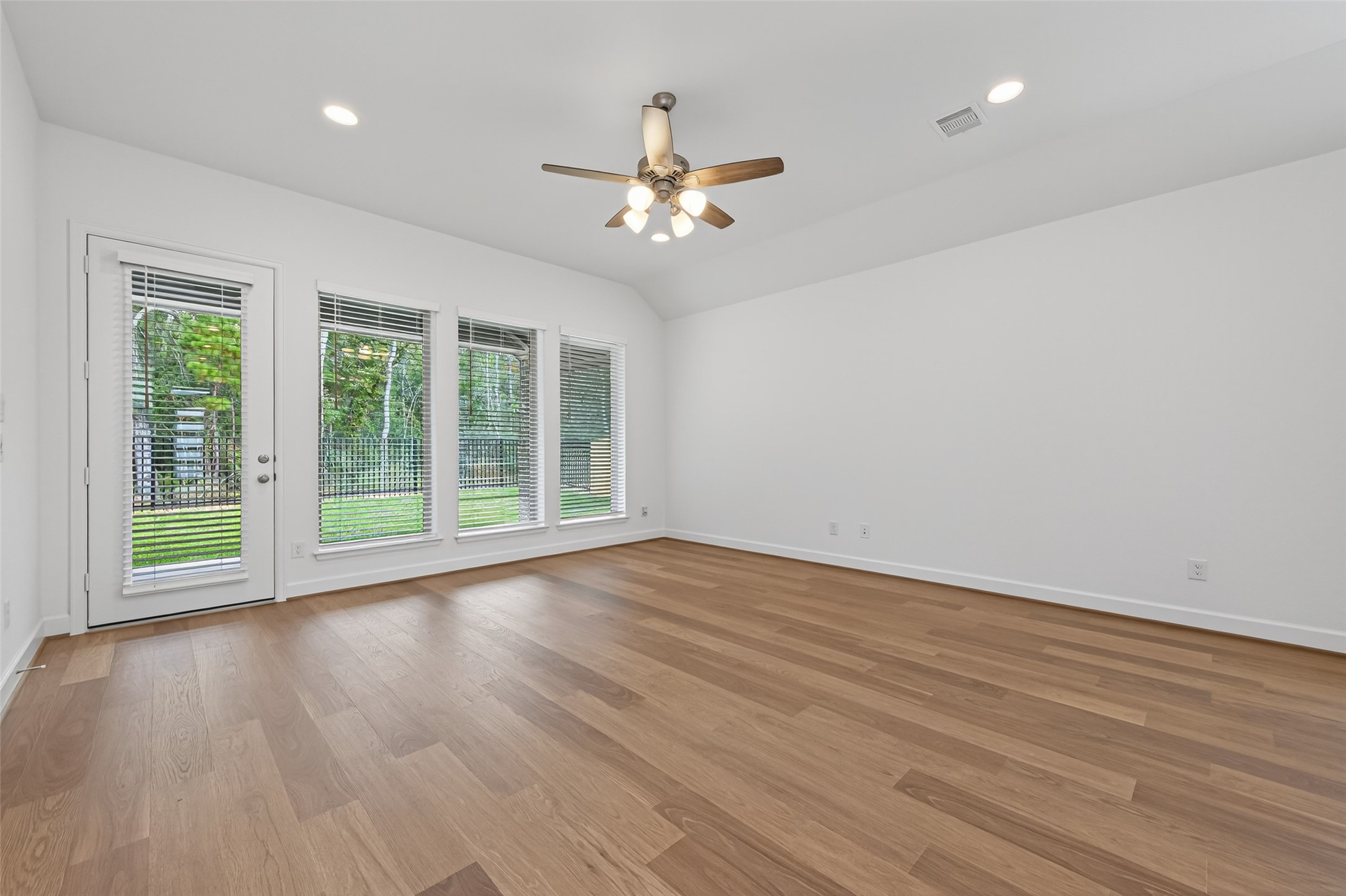 122 Sierra Strm Court Conroe, TX 77304 - Photo 17 of 40 a view of an empty room with wooden floor and a window